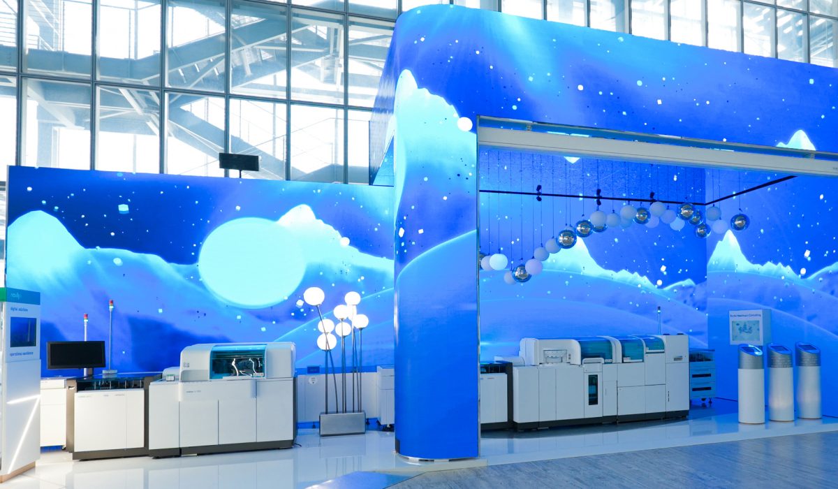 A panoramic view of the mass spec launch box at the Roche booth during EuroMedLab Rome, designed by OH37.