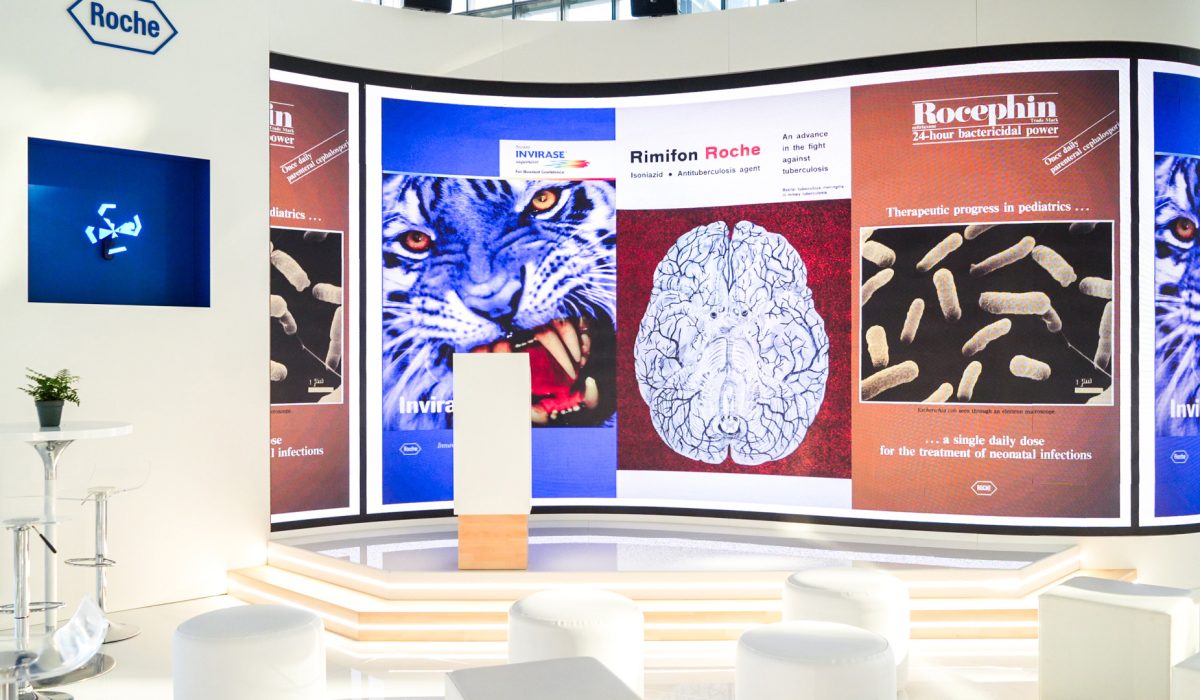 Roche Diagnostics EML Rome stage with archival scientific visuals